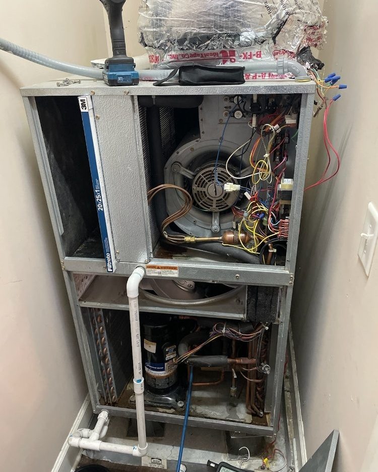 An open air handler with its wiring exposed