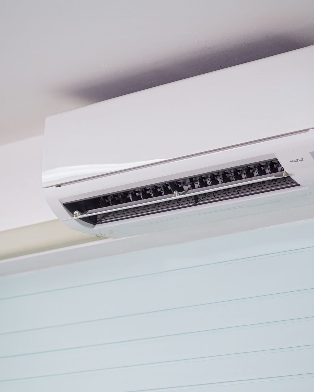 A wall-mounted ductless mini-split unit in a modern interior