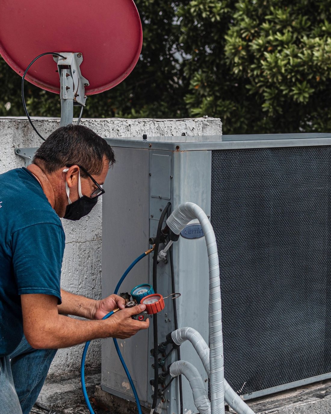 A technician checking a residential air conditioner