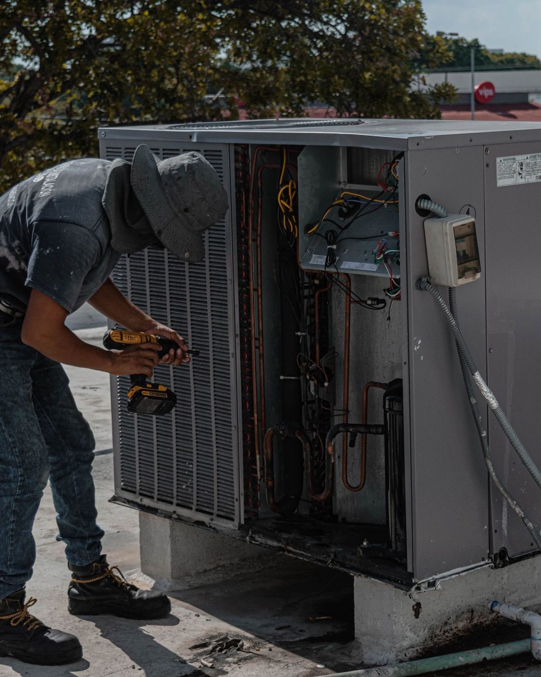 A technician repairing an air conditioner