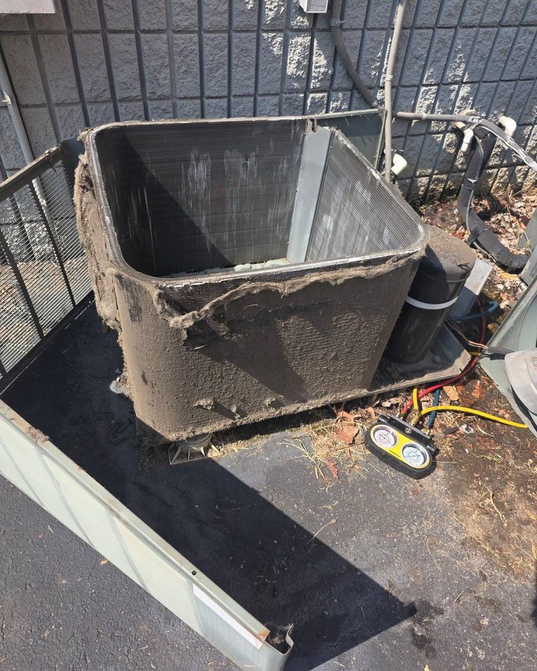 A condenser coil caked with dirt, before cleaning