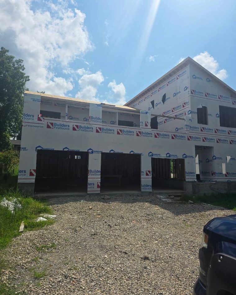 A wrapped new-construction house before the equipment goes in